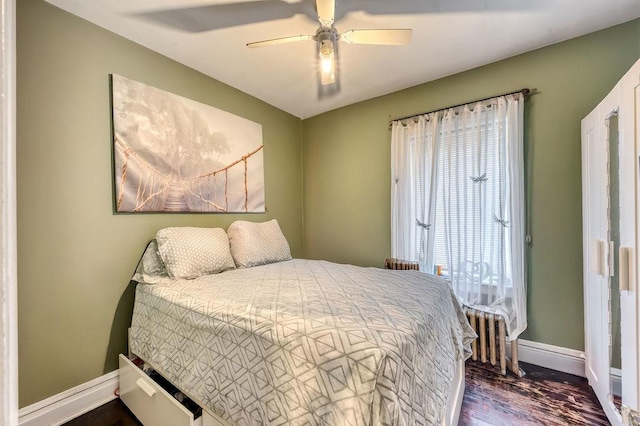 bedroom with ceiling fan, dark hardwood / wood-style flooring, and multiple windows