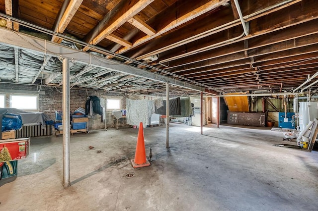 basement featuring gas water heater and a wealth of natural light