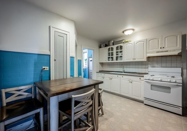 kitchen with white cabinetry, sink, and white gas range oven