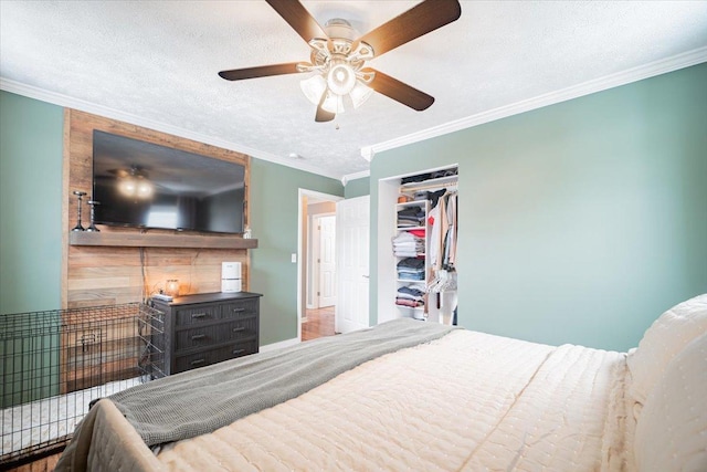 bedroom featuring ceiling fan, a closet, crown molding, and a textured ceiling