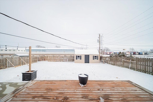 snow covered deck featuring an outbuilding