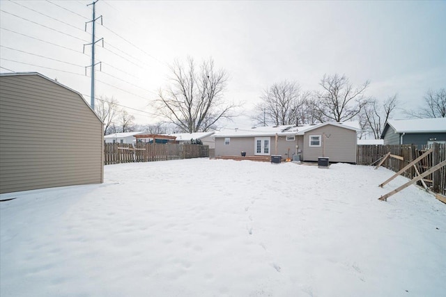 snowy yard featuring central AC unit