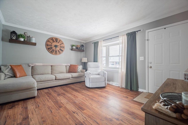 living room with crown molding, a textured ceiling, and hardwood / wood-style flooring