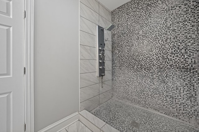 bathroom with a tile shower