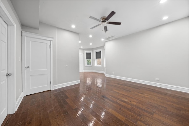 unfurnished living room featuring ceiling fan and dark hardwood / wood-style flooring