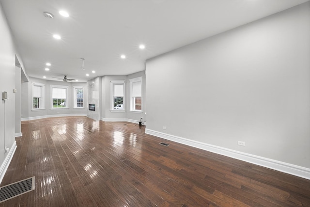 unfurnished living room featuring ceiling fan and hardwood / wood-style flooring