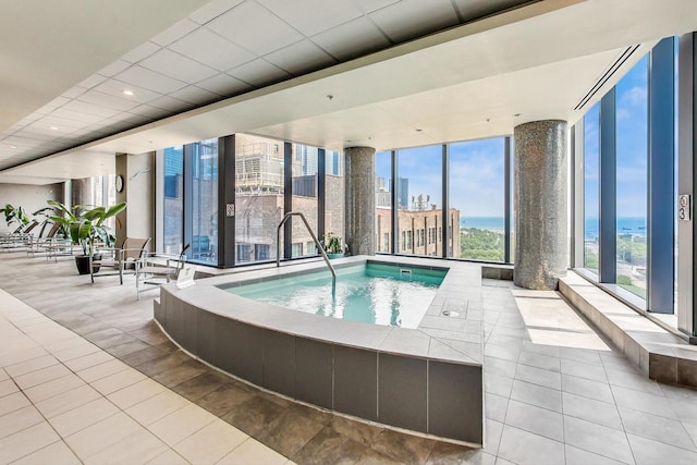 view of swimming pool with an indoor hot tub