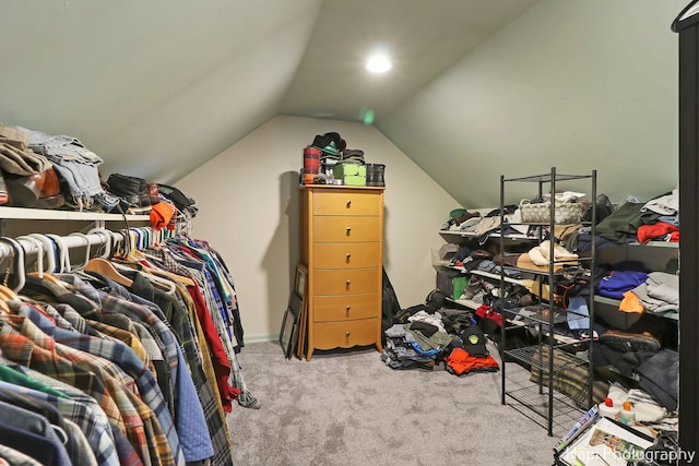 walk in closet featuring vaulted ceiling and light carpet