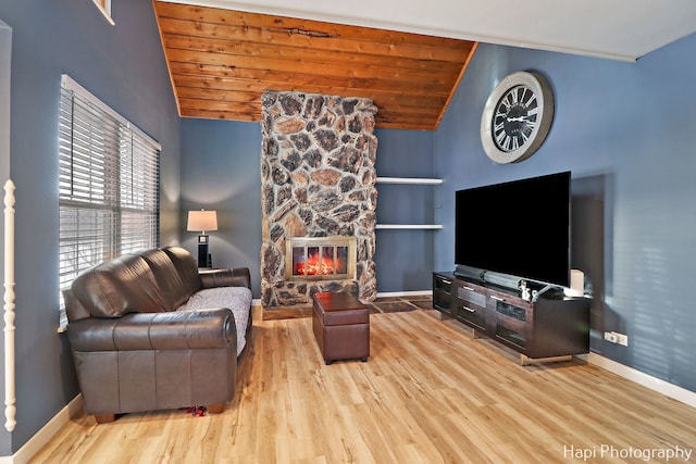 living room featuring wooden ceiling, a fireplace, lofted ceiling, light hardwood / wood-style flooring, and built in shelves