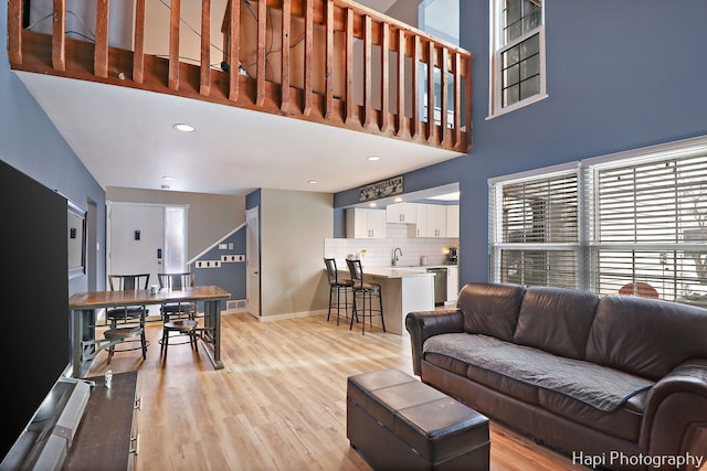 living room featuring light hardwood / wood-style floors and sink