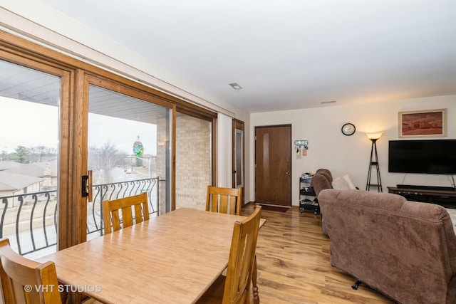 dining space with light hardwood / wood-style flooring