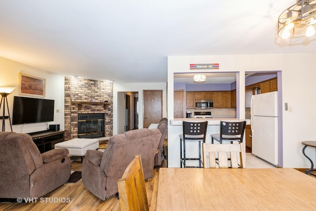 living room with a fireplace and light hardwood / wood-style floors