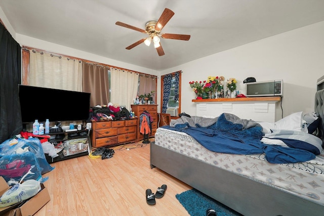 bedroom featuring ceiling fan and wood-type flooring