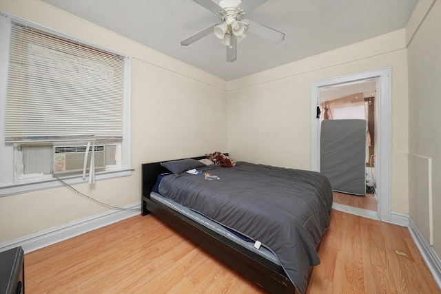 bedroom with light hardwood / wood-style floors and ceiling fan