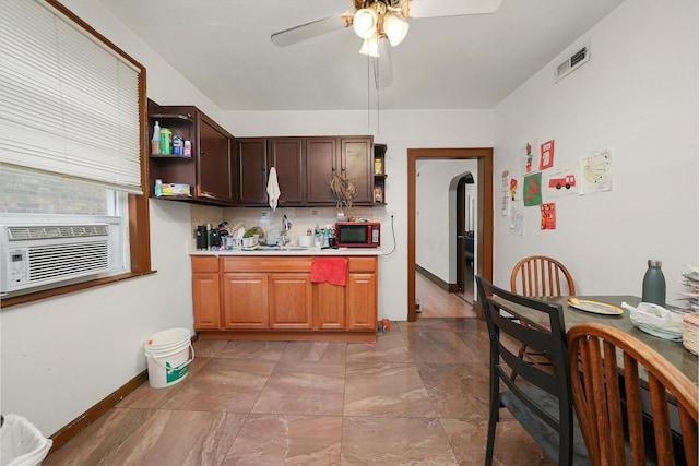 kitchen featuring tasteful backsplash, ceiling fan, cooling unit, and sink