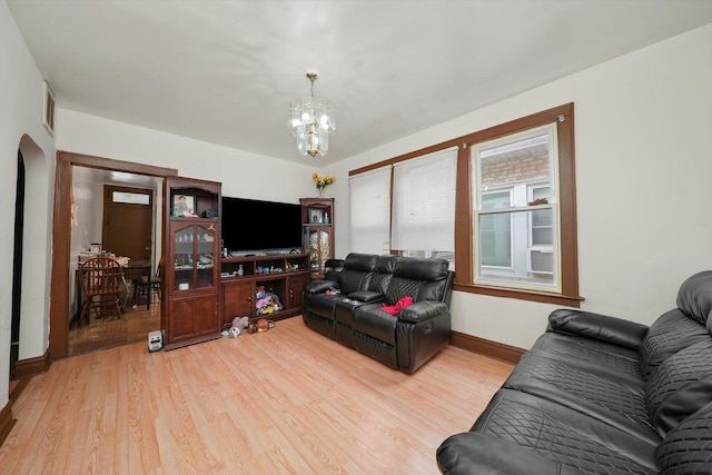 living room with a chandelier and wood-type flooring