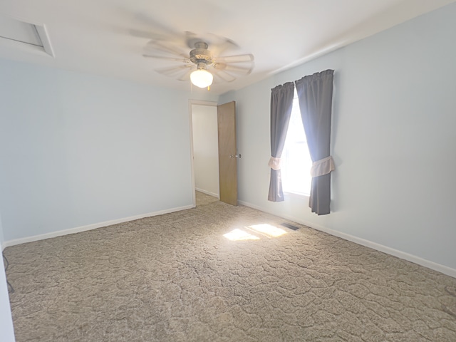 carpeted spare room with ceiling fan