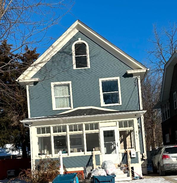 rear view of property featuring a sunroom