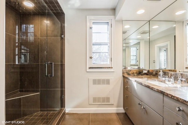 bathroom featuring vanity, tile patterned floors, and walk in shower