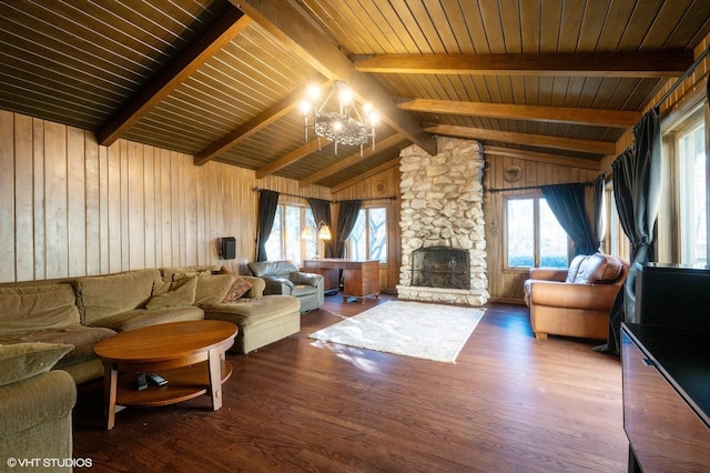 living room with a fireplace, lofted ceiling with beams, a healthy amount of sunlight, and wood ceiling