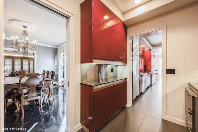 kitchen with pendant lighting, ornamental molding, and an inviting chandelier