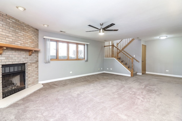 unfurnished living room featuring a fireplace, ceiling fan, and carpet