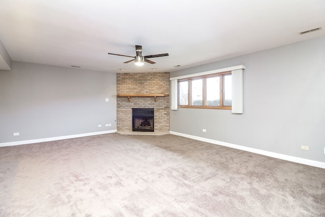 unfurnished living room featuring carpet, ceiling fan, and a brick fireplace