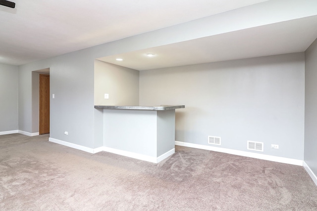 interior space featuring carpet floors and bar