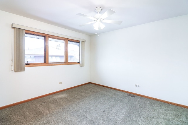 unfurnished room with ceiling fan and carpet