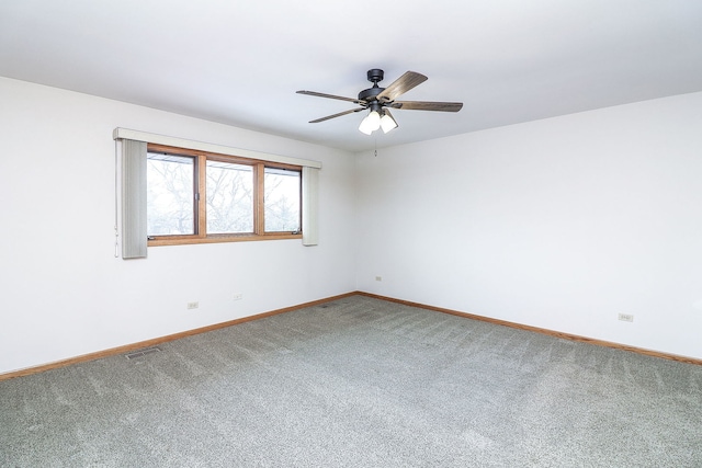 empty room featuring carpet floors and ceiling fan