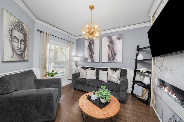 living room with dark hardwood / wood-style flooring, a chandelier, and ornamental molding