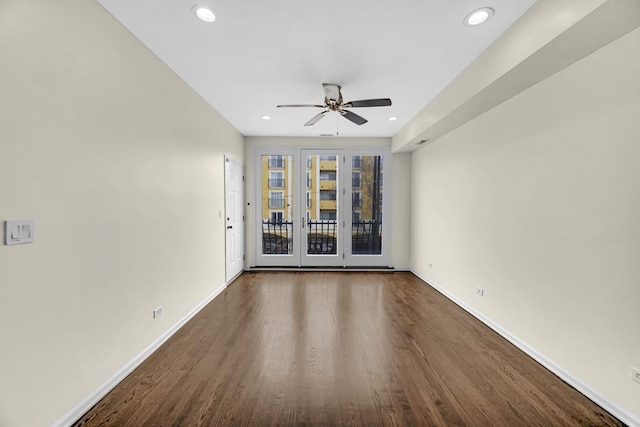 unfurnished room with ceiling fan and dark hardwood / wood-style flooring