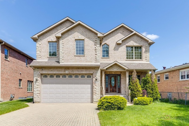 view of front of home featuring a garage and a front lawn