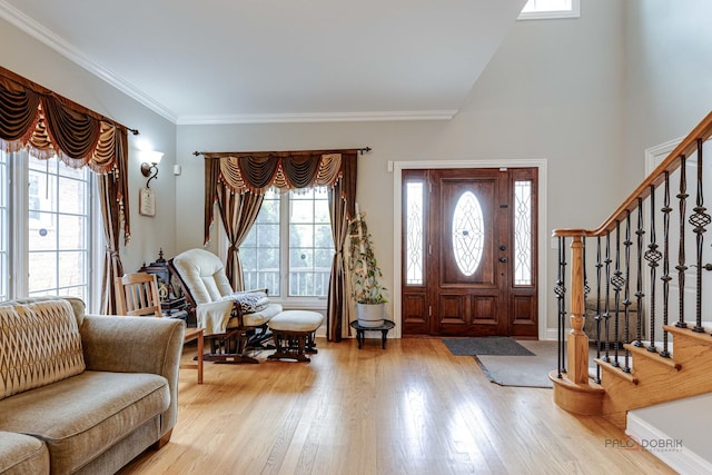 entryway featuring light hardwood / wood-style flooring and ornamental molding