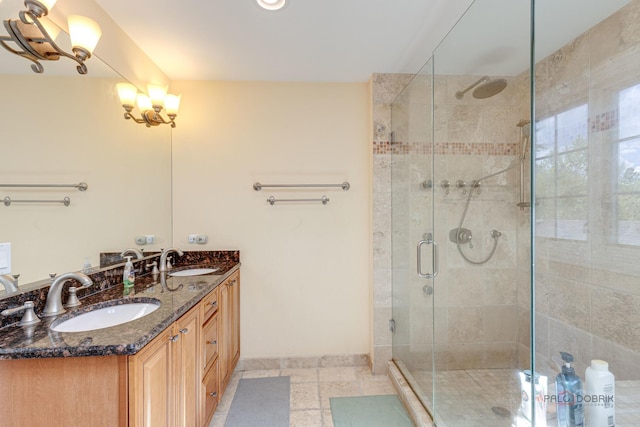 bathroom with tile patterned floors, vanity, and a shower with door