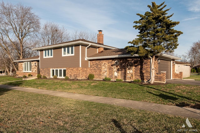 split level home featuring a front yard and a garage