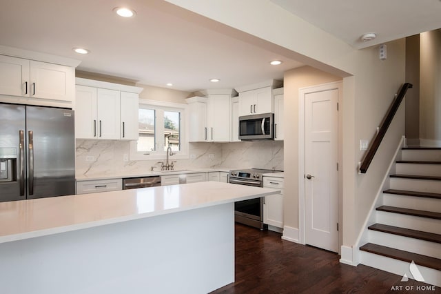 kitchen with white cabinetry, sink, dark hardwood / wood-style floors, and appliances with stainless steel finishes