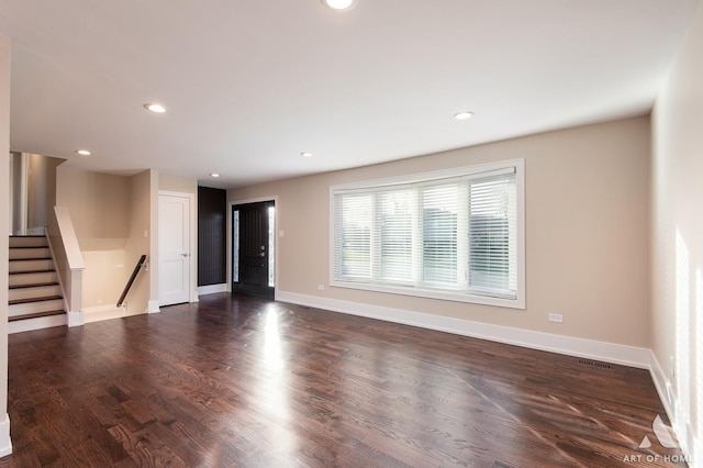 unfurnished living room with dark hardwood / wood-style floors