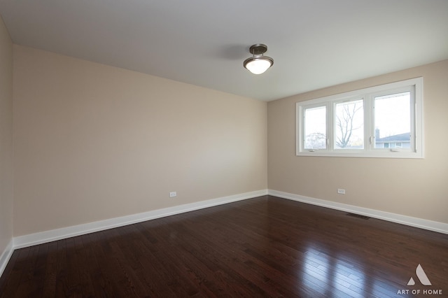 unfurnished room with dark hardwood / wood-style flooring