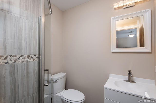 bathroom featuring a shower, vanity, and toilet