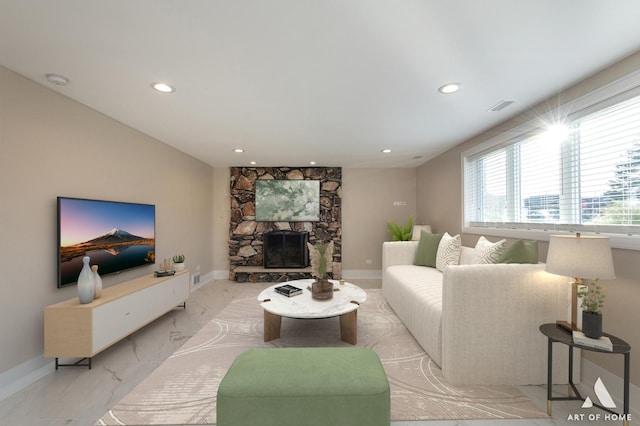 living room with a stone fireplace