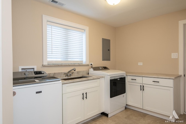 washroom with cabinets, sink, electric panel, and washing machine and clothes dryer