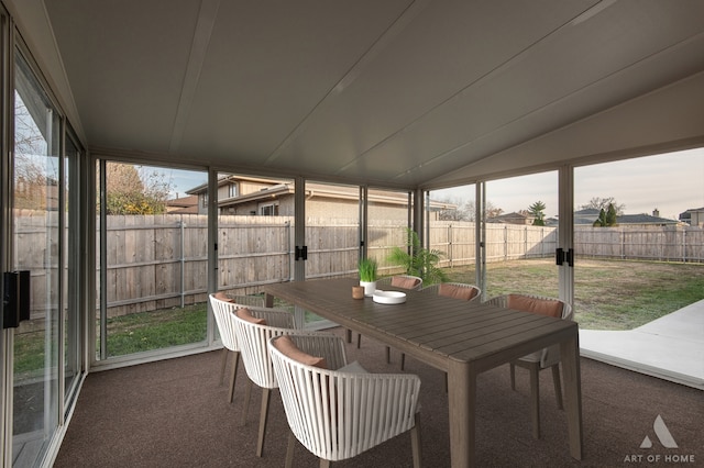 sunroom featuring vaulted ceiling