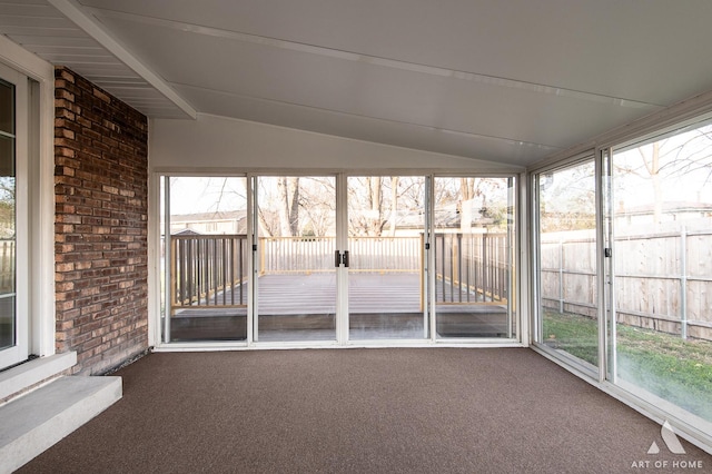 unfurnished sunroom with lofted ceiling