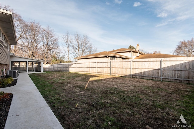 view of yard featuring central AC and a sunroom