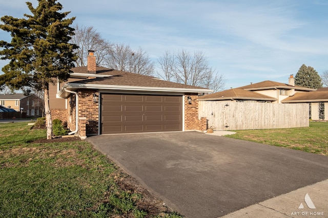 view of side of property featuring a lawn and a garage