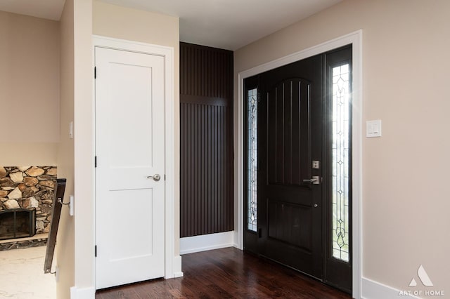 foyer featuring dark hardwood / wood-style floors and a fireplace