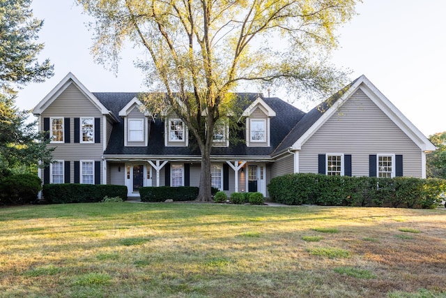 cape cod home with a front lawn