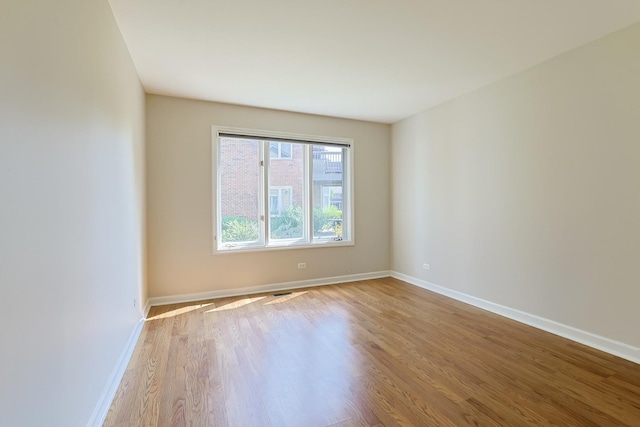 spare room with light hardwood / wood-style flooring