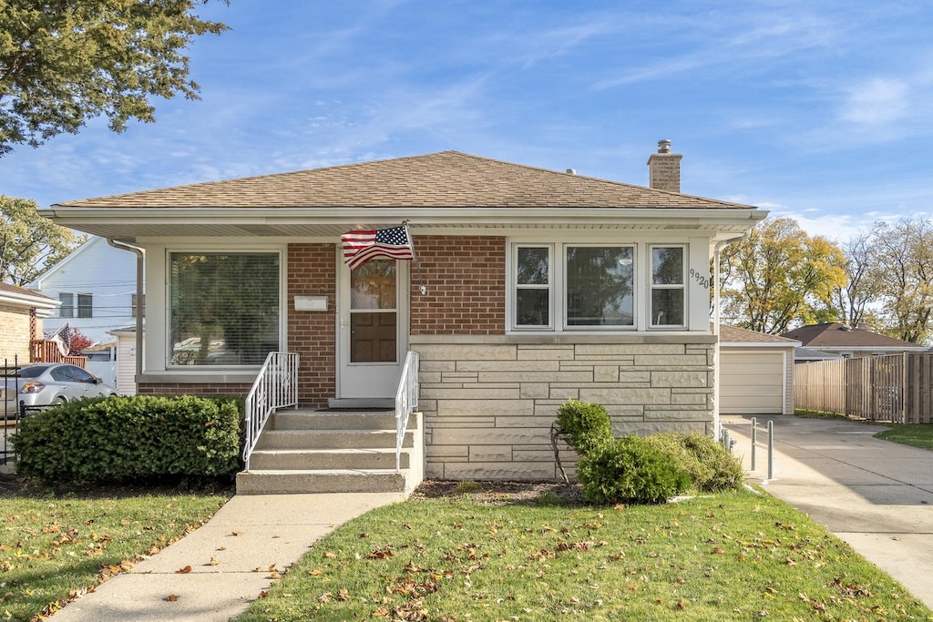 bungalow-style home featuring a front yard and a garage